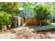 Private backyard with wooden fence, shed, and ramp; ideal for outdoor storage and accessibility at 3029 Wycliff Rd, Raleigh, NC 27607