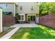 Fenced-in backyard with a small grass area and concrete patio, AC unit, and a sliding glass door at 3029 Wycliff Rd, Raleigh, NC 27607