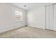 A clean, carpeted bedroom with window and closet, ready to be furnished at 3029 Wycliff Rd, Raleigh, NC 27607