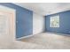 Spacious carpeted bedroom with a large window, closet, and neutral paint at 3029 Wycliff Rd, Raleigh, NC 27607