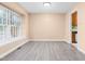 Sunny dining area boasts a bright window and sleek floors, with a glimpse into the kitchen at 3029 Wycliff Rd, Raleigh, NC 27607