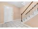 Bright foyer with white door, white tile flooring, a carpeted staircase, and neutral paint at 3029 Wycliff Rd, Raleigh, NC 27607