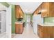 Functional kitchen layout with wooden cabinets, white appliances, and neutral countertops at 3029 Wycliff Rd, Raleigh, NC 27607