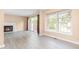 Bright living room features a fireplace, large window, and sliding doors to back, and modern floors at 3029 Wycliff Rd, Raleigh, NC 27607