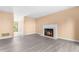 Open living space featuring modern floors, a fireplace, and a doorway leading to a sunny patio at 3029 Wycliff Rd, Raleigh, NC 27607