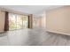 Spacious living room with sliding glass doors to backyard, neutral walls, and modern floors at 3029 Wycliff Rd, Raleigh, NC 27607