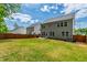 Large backyard featuring a well-maintained lawn, patio area, and fenced perimeter for outdoor enjoyment at 303 Forestview Crest Way, Fuquay Varina, NC 27526