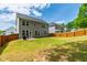 Expansive fenced backyard with green grass and ample space for recreation and entertaining, perfect for outdoor living at 303 Forestview Crest Way, Fuquay Varina, NC 27526
