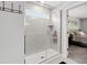 Modern bathroom featuring glass shower doors and a view of the main bedroom at 303 Forestview Crest Way, Fuquay Varina, NC 27526