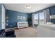 Well-lit Bedroom with a crib, changing table, and soft blue walls at 303 Forestview Crest Way, Fuquay Varina, NC 27526