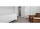 Bright bedroom showcasing a comfortable chair and access to the hallway at 303 Forestview Crest Way, Fuquay Varina, NC 27526