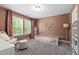 bedroom with good natural light, plush carpet and a rocking chair at 303 Forestview Crest Way, Fuquay Varina, NC 27526