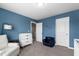 Bedroom with a small chair, closet, and a doorway to another room at 303 Forestview Crest Way, Fuquay Varina, NC 27526