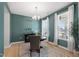 Elegant dining room with a modern chandelier, hardwood floors, and bright natural light at 303 Forestview Crest Way, Fuquay Varina, NC 27526