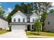 Beautiful two-story home features a well-manicured lawn and attached two-car garage at 303 Forestview Crest Way, Fuquay Varina, NC 27526
