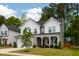 Charming two-story home boasts a covered front porch and manicured lawn at 303 Forestview Crest Way, Fuquay Varina, NC 27526
