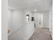 Upstairs hallway with carpet floors and doors leading to various rooms at 303 Forestview Crest Way, Fuquay Varina, NC 27526