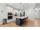 Modern kitchen with white cabinets, stainless steel appliances, and a large island with seating at 303 Forestview Crest Way, Fuquay Varina, NC 27526