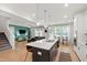 Spacious open-concept kitchen with island, modern appliances, and seamless flow to the living room at 303 Forestview Crest Way, Fuquay Varina, NC 27526