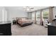 Serene main bedroom with large windows, carpet flooring, and a spacious layout at 303 Forestview Crest Way, Fuquay Varina, NC 27526
