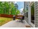 Cozy patio setup with a grill, table, and chairs, perfect for outdoor relaxation and entertaining at 303 Forestview Crest Way, Fuquay Varina, NC 27526