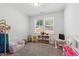 Adorable room with a play kitchen, small couch, and a window with natural light at 303 Forestview Crest Way, Fuquay Varina, NC 27526