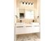 This bathroom features double sinks, hexagon tile flooring, and an illuminated mirror at 305 W Waddell St, Selma, NC 27576