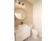 Stylish powder room featuring a round mirror, vessel sink, and sleek fixtures at 305 W Waddell St, Selma, NC 27576