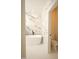 The bathroom features a modern soaking tub and marble look tile at 305 W Waddell St, Selma, NC 27576