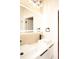 This bathroom features double sinks, hexagon tile flooring, and an illuminated mirror at 305 W Waddell St, Selma, NC 27576