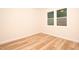 Bright, minimalist bedroom with hardwood floors and a large window at 305 W Waddell St, Selma, NC 27576
