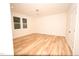This bedroom features wood-look flooring and a window with white trim at 305 W Waddell St, Selma, NC 27576