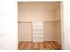 This walk-in closet offers wood-look flooring and built in shelving at 305 W Waddell St, Selma, NC 27576