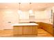 Bright, modern kitchen featuring an island, white cabinets, and stainless steel appliances at 305 W Waddell St, Selma, NC 27576