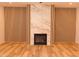 Modern living room showcases a marble fireplace wall and hardwood flooring at 305 W Waddell St, Selma, NC 27576