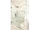 Beautiful bathroom with a glass enclosed shower and stunning marble tile surround at 305 W Waddell St, Selma, NC 27576