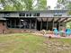 Beautiful backyard featuring a patio with a fire pit and plenty of seating perfect for entertaining outdoors at 307 Clayton Rd, Chapel Hill, NC 27514