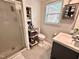 This bathroom has a shower, shelving and a gray vanity at 307 Clayton Rd, Chapel Hill, NC 27514