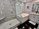 Updated bathroom featuring a whirlpool tub, glass shower, granite countertops and tiled floors at 307 Clayton Rd, Chapel Hill, NC 27514