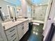Stylish primary bathroom featuring tiled floors, vanity with granite countertop, and glass shower at 307 Clayton Rd, Chapel Hill, NC 27514