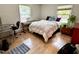This bedroom has hardwood floors, two windows, and is staged with a bed and piano at 307 Clayton Rd, Chapel Hill, NC 27514