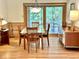 Bright dining area with a glass table, wooden chairs, and large windows offering scenic outdoor views at 307 Clayton Rd, Chapel Hill, NC 27514