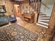 Cozy foyer featuring a wooden staircase, charming piano, and decorative rug at 307 Clayton Rd, Chapel Hill, NC 27514