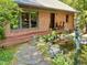 Charming brick home featuring an intricate water feature and manicured landscaping at 307 Clayton Rd, Chapel Hill, NC 27514