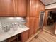 Eat-in kitchen with wood cabinets, tiled backsplash, stainless steel appliances and decorative lighting at 307 Clayton Rd, Chapel Hill, NC 27514