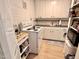This kitchen has white cabinets and appliances and light colored flooring at 307 Clayton Rd, Chapel Hill, NC 27514