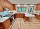 Open-concept kitchen boasts a breakfast bar, stainless steel appliances, and custom cabinetry at 307 Clayton Rd, Chapel Hill, NC 27514