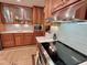 Close-up of the kitchen features modern appliances, light backsplash, and custom wood cabinetry at 307 Clayton Rd, Chapel Hill, NC 27514