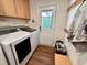 Bright laundry room with washer, dryer, utility sink and access door to backyard at 307 Clayton Rd, Chapel Hill, NC 27514