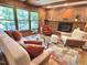Bright living room with a brick fireplace, hardwood floors, and elegant furniture at 307 Clayton Rd, Chapel Hill, NC 27514